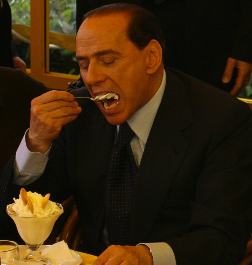 Naples, ITALY:  Former Italian Prime Minister Silvio Berlusconi eats an ice-cream sundae in the neapolitan cafetteria Ciro a Mergellina, Naples, 05 May 2006.  Berlusconi is in Naples to present Forza Italia candidates as leader of the party's  list for the Naples municipal elections set May 28.  (Photo credit should read FRANCESCO PISCHETOLA/AFP/Getty Images)